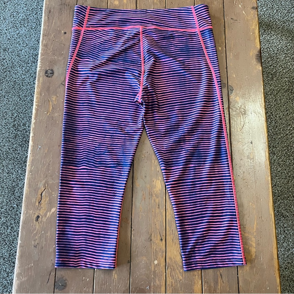 Under Armour HeatGear compression capri leggings in a navy and pink stripes